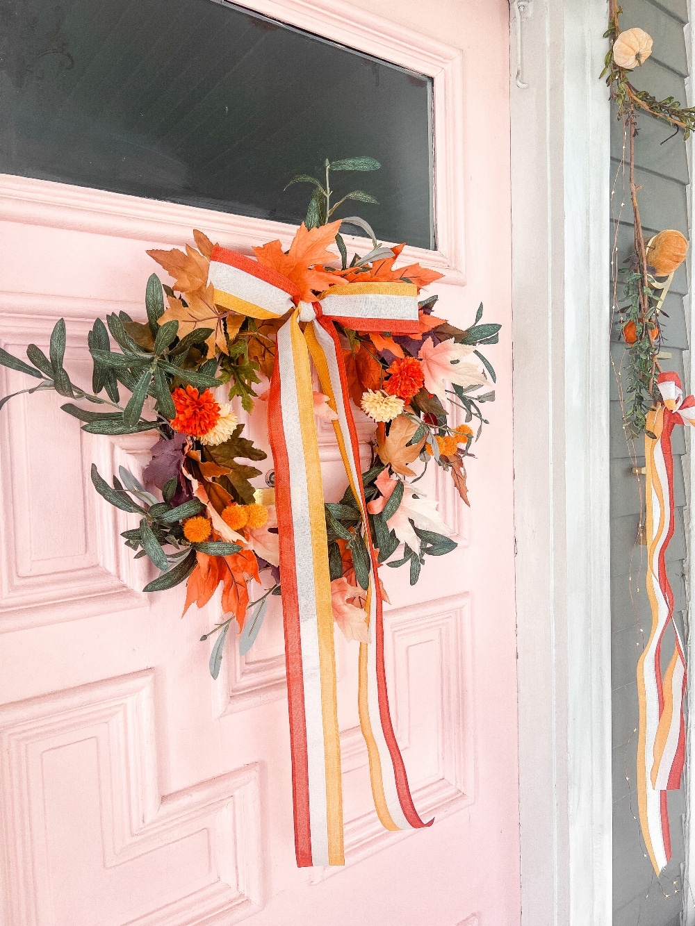 Candy Corn-Colored Fall Porch with Stacked Pumpkins. Create a warm, inviting fall porch with the coolest stacked pumpkins, a vibrant DIY wreath, and layered plaid rugs for a festive, seasonal touch.