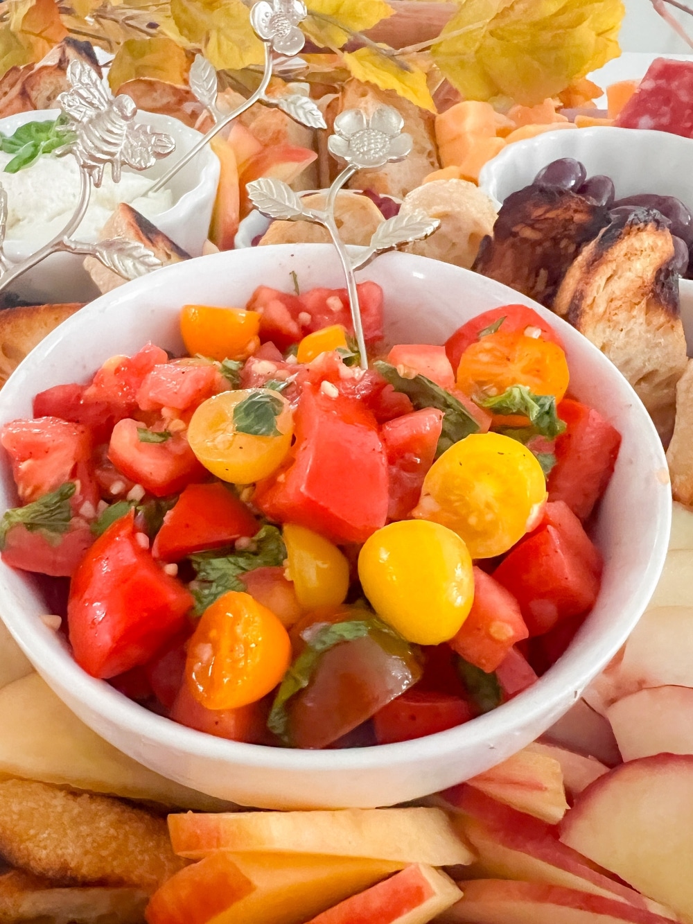 Fall Bruschetta Charcuterie Board. How to create a Fall Bruschetta Party Board featuring grilled baguette slices, a fresh bruschetta topping, and a variety of toppings for a fun and flavorful autumn gathering. 