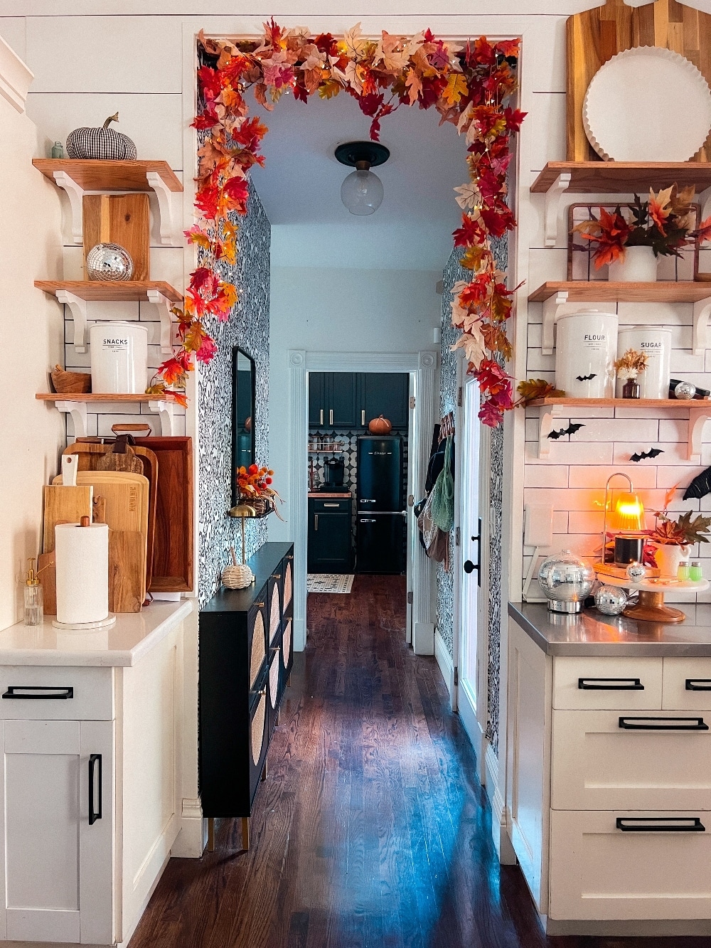 Easy Fall Over the Door Lighted Garland. Create an easy and festive fall over-the-door garland using inexpensive leaf garlands, twinkle lights, and a shower curtain rod, perfect for autumn decor.