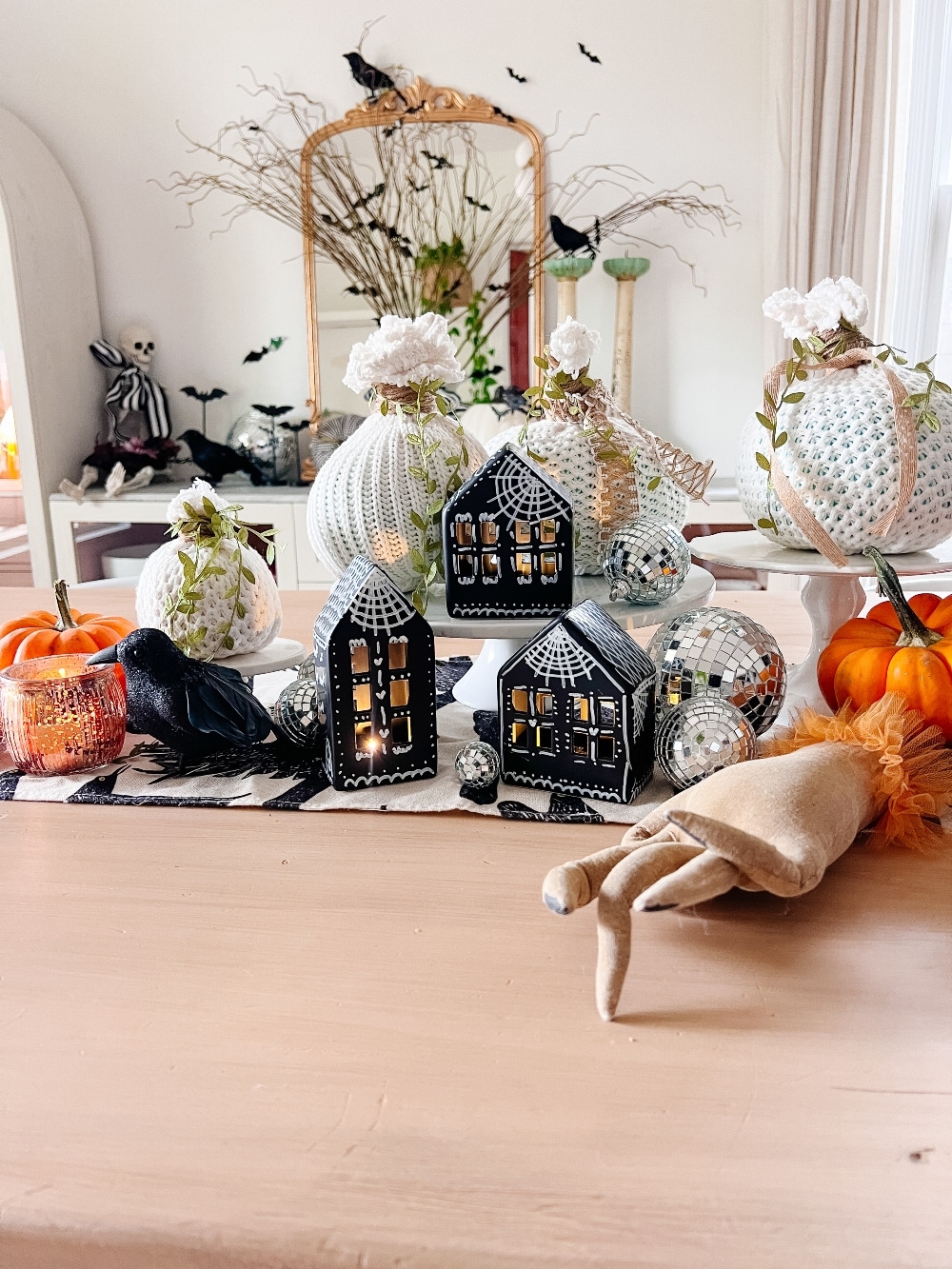 DIY Halloween Gingerbread Village. Make a DIY Spooky Gingerbread Village by painting small houses black and adding spooky touches like webs and ghosts for a fun Halloween twist! 