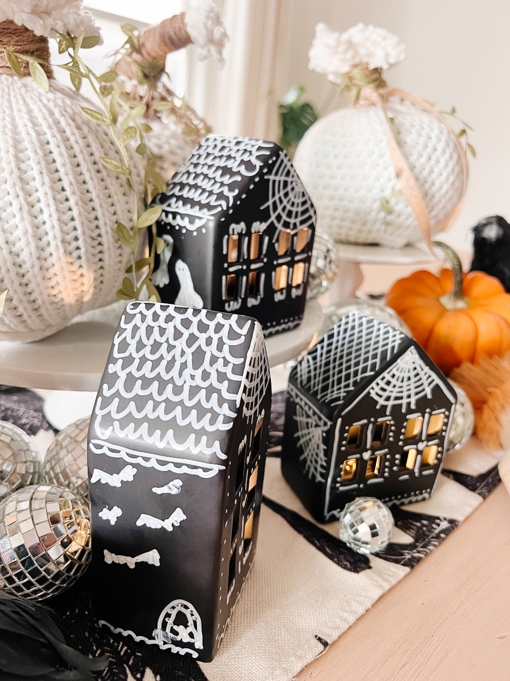 DIY Halloween Gingerbread Village. Make a DIY Spooky Gingerbread Village by painting small houses black and adding spooky touches like webs and ghosts for a fun Halloween twist! 