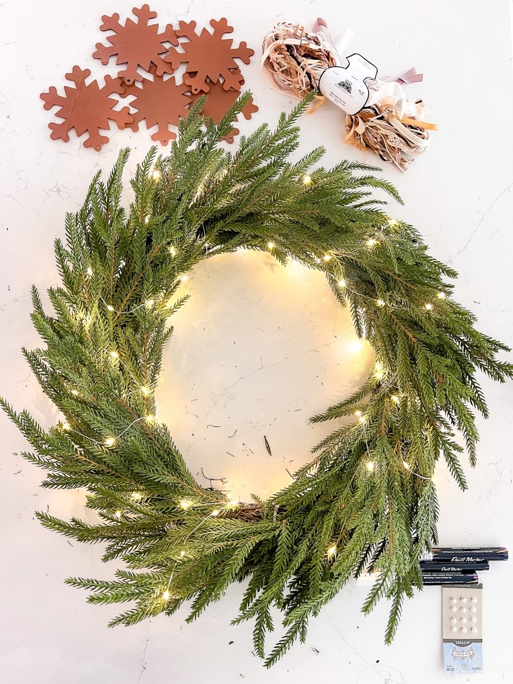 DIY Gingerbread Christmas Wreath. Create a whimsical gingerbread-themed Christmas wreath in just a few simple steps with this easy DIY tutorial!