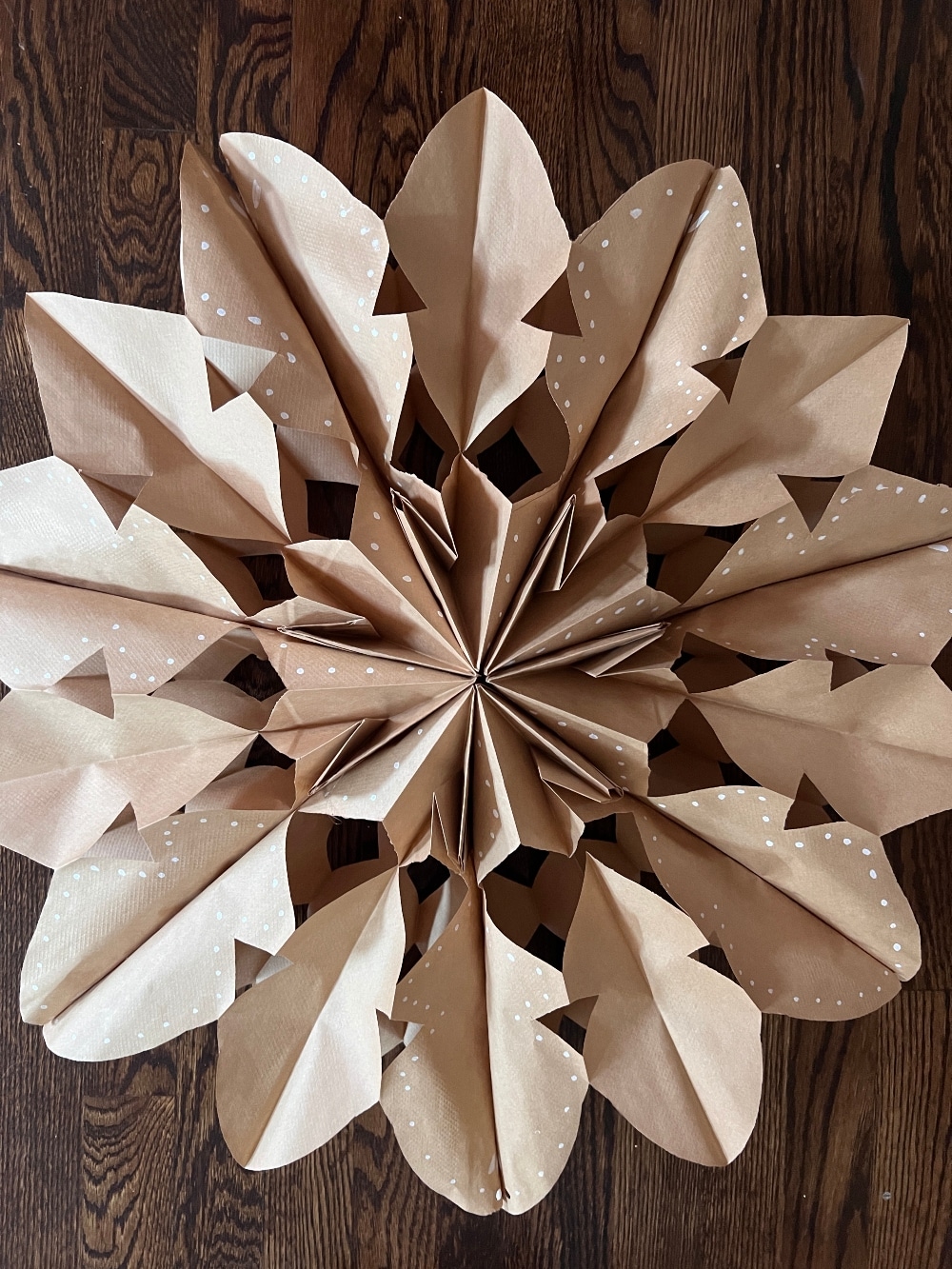 DIY Paper Bag Gingerbread Snowflakes. Transform simple paper bags into stunning gingerbread-inspired snowflakes for festive, budget-friendly holiday decor!