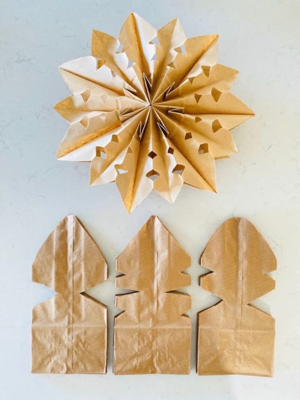 DIY Paper Bag Gingerbread Snowflakes. Transform simple paper bags into stunning gingerbread-inspired snowflakes for festive, budget-friendly holiday decor!