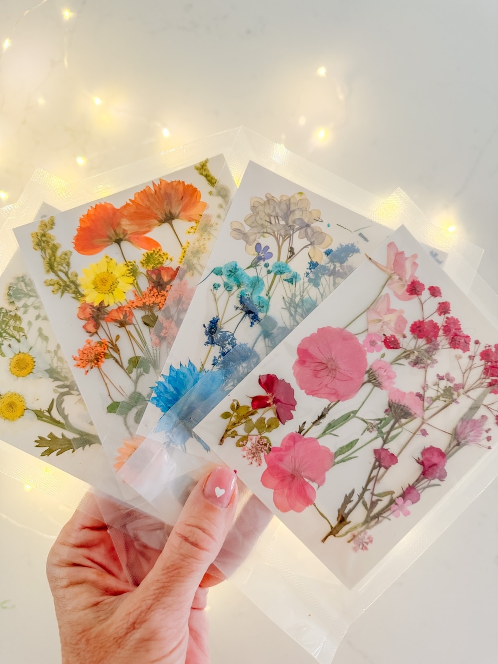 DIY Spring Flower Lanterns. Welcome spring by creating DIY spring flower lanterns with dried flowers, Mod Podge, and glowing candles!