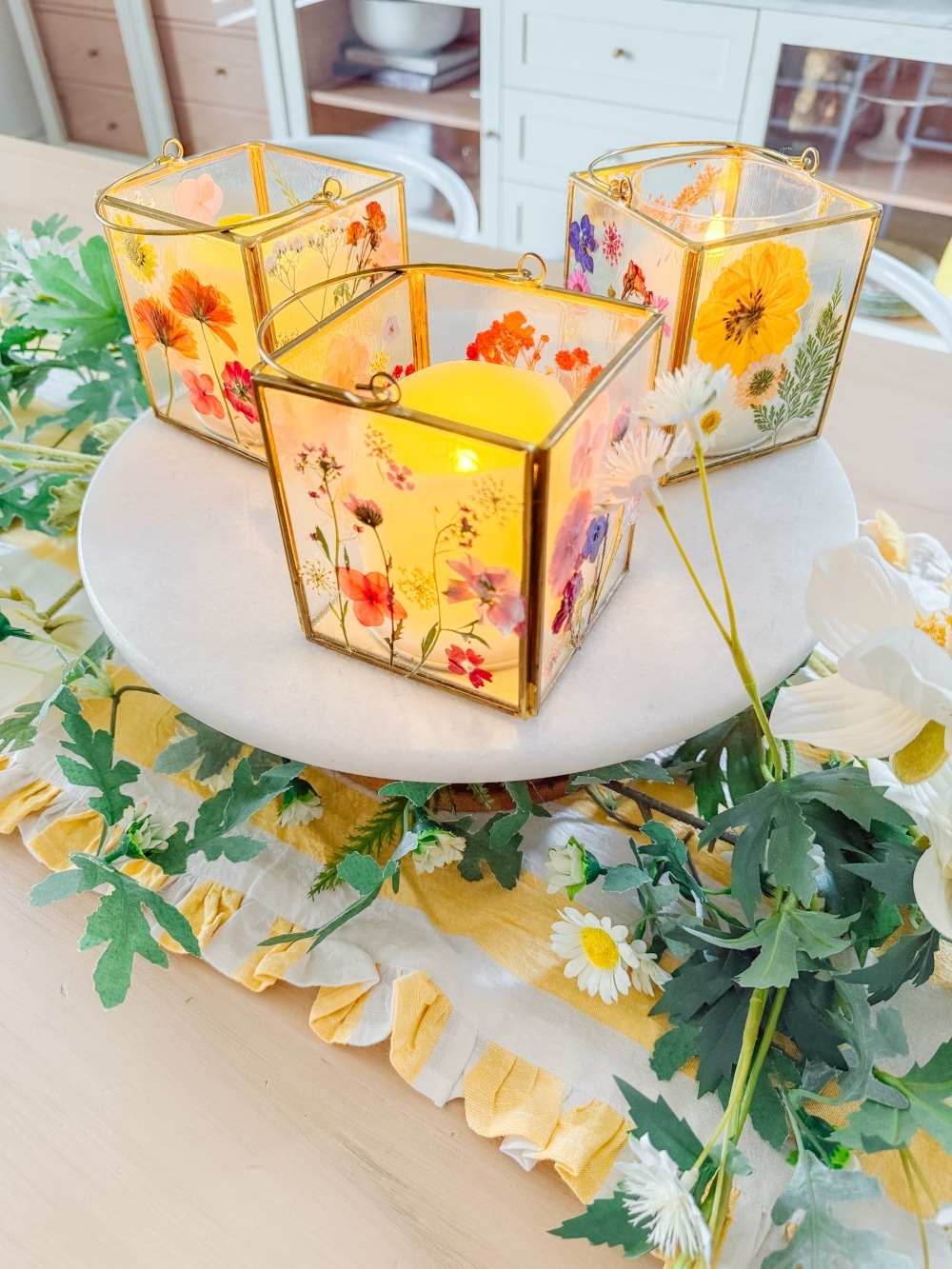 DIY Spring Flower Lanterns. Welcome spring by creating DIY spring flower lanterns with dried flowers, Mod Podge, and glowing candles!