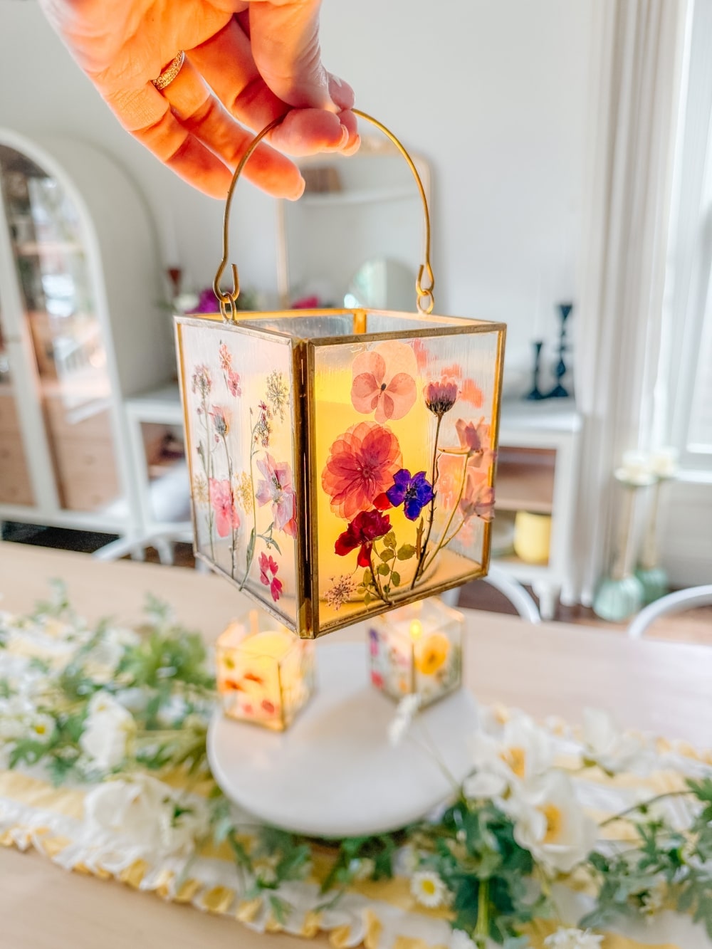 DIY Spring Flower Lanterns. Welcome spring by creating DIY spring flower lanterns with dried flowers, Mod Podge, and glowing candles!