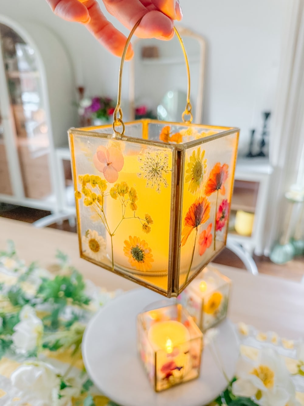 DIY Spring Flower Lanterns. Welcome spring by creating DIY spring flower lanterns with dried flowers, Mod Podge, and glowing candles!