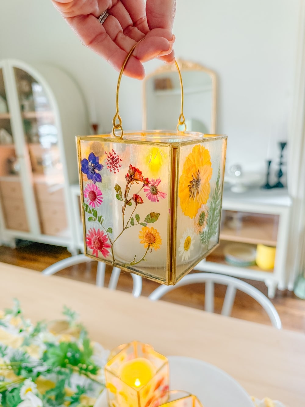 DIY Spring Flower Lanterns. Welcome spring by creating DIY spring flower lanterns with dried flowers, Mod Podge, and glowing candles!