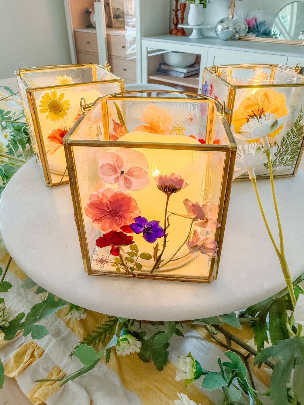 DIY Spring Flower Lanterns. Welcome spring by creating DIY spring flower lanterns with dried flowers, Mod Podge, and glowing candles!