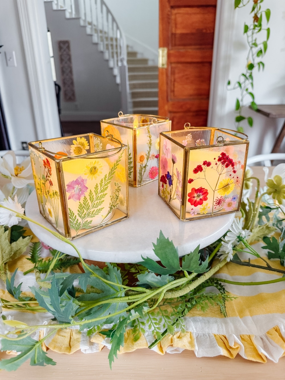 DIY Spring Flower Lanterns. Welcome spring by creating DIY spring flower lanterns with dried flowers, Mod Podge, and glowing candles!