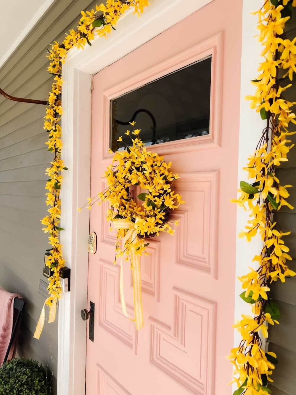 DIY Forsythia Spring Porch! Create a fresh and welcoming spring porch in minutes with vibrant forsythia faux florals, a DIY wreath, a teapot planter and cheerful accents!