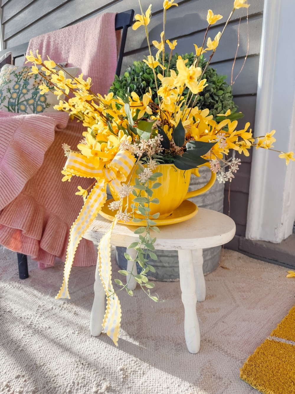 DIY Forsythia Spring Porch! Create a fresh and welcoming spring porch in minutes with vibrant forsythia faux florals, a DIY wreath, a teapot planter and cheerful accents!