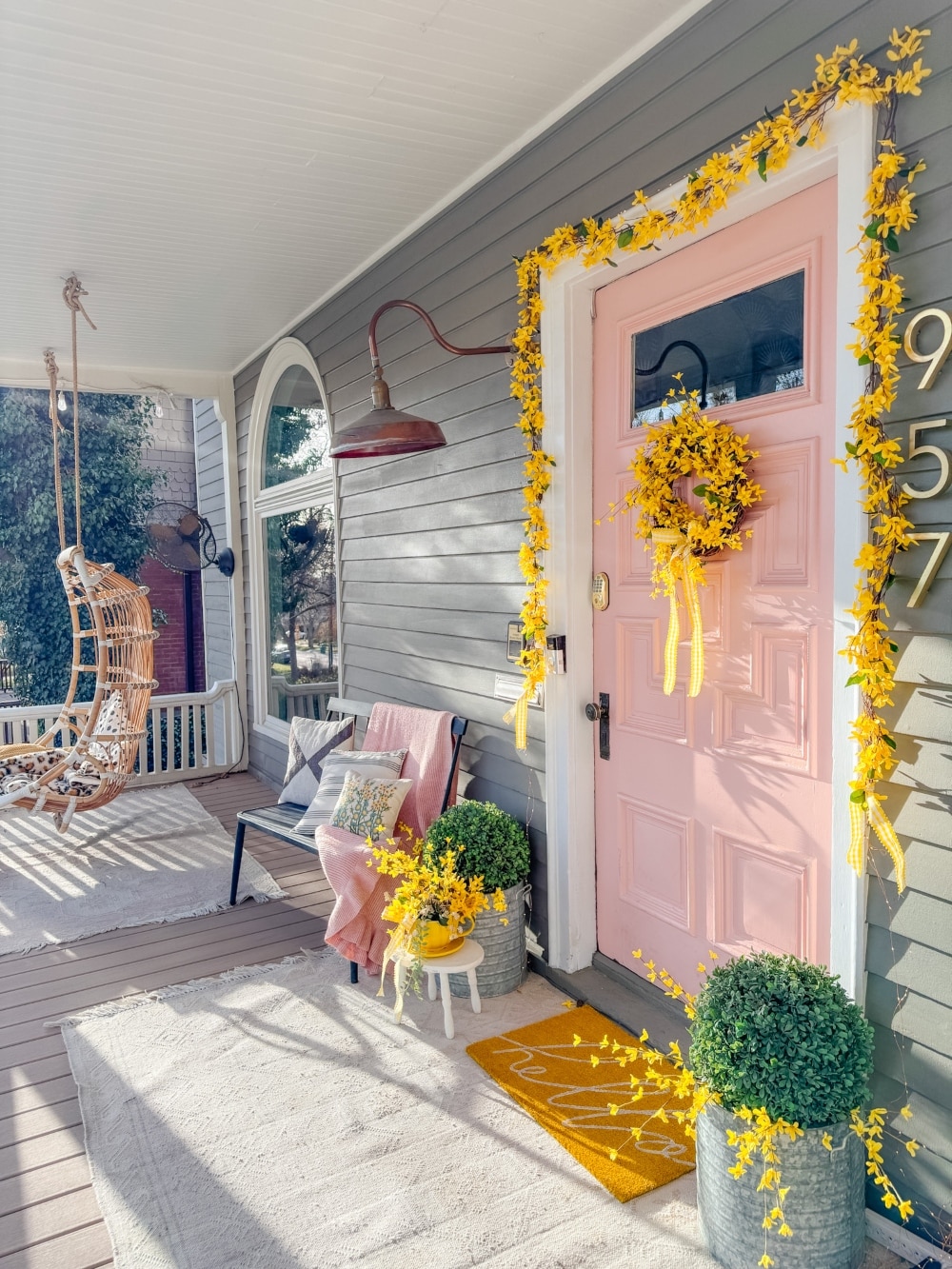 DIY Forsythia Spring Porch! Create a fresh and welcoming spring porch in minutes with vibrant forsythia faux florals, a DIY wreath, a teapot planter and cheerful accents!