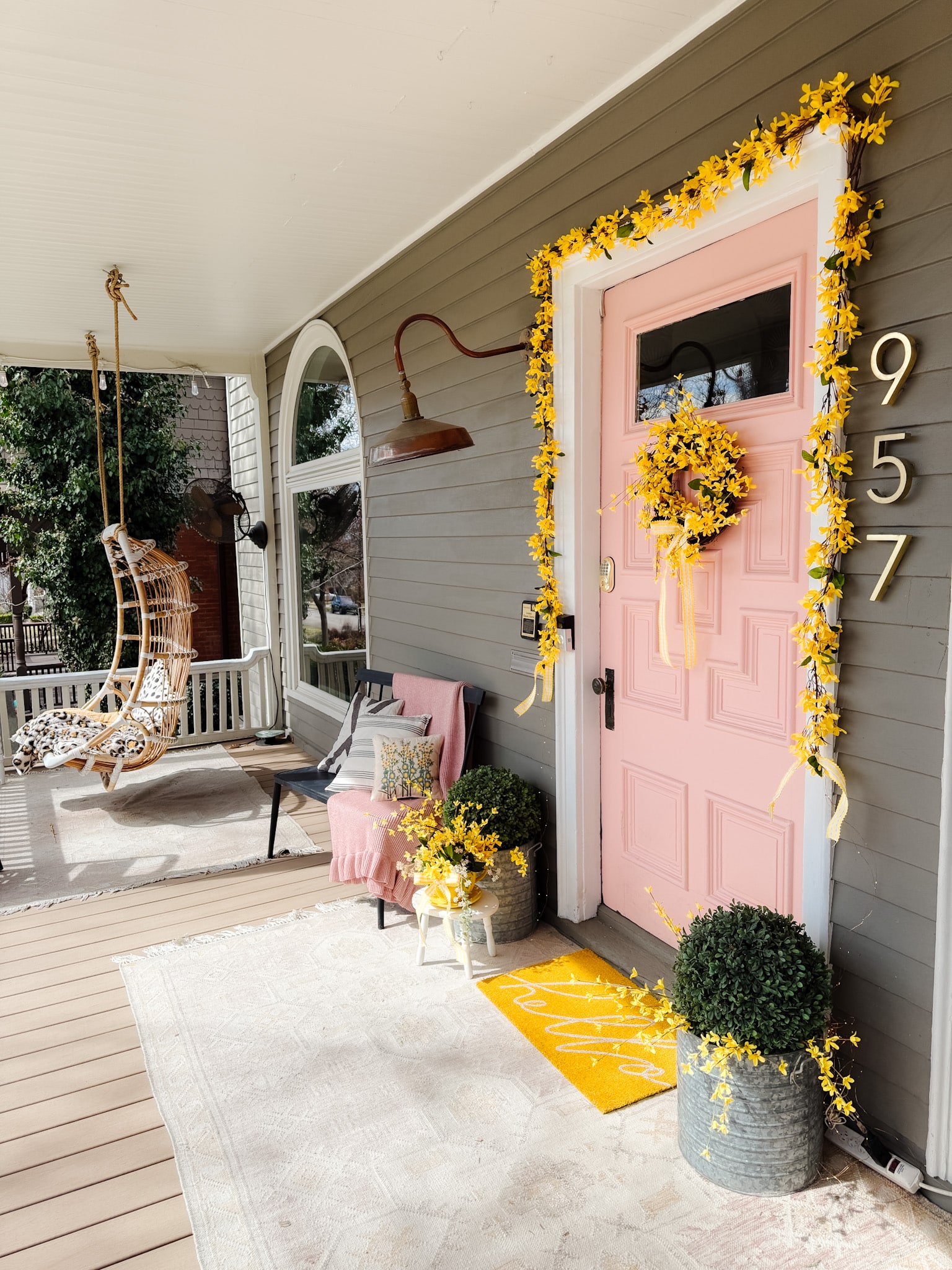 DIY Forsythia Spring Porch! Create a fresh and welcoming spring porch in minutes with vibrant forsythia faux florals, a DIY wreath, a teapot planter and cheerful accents!