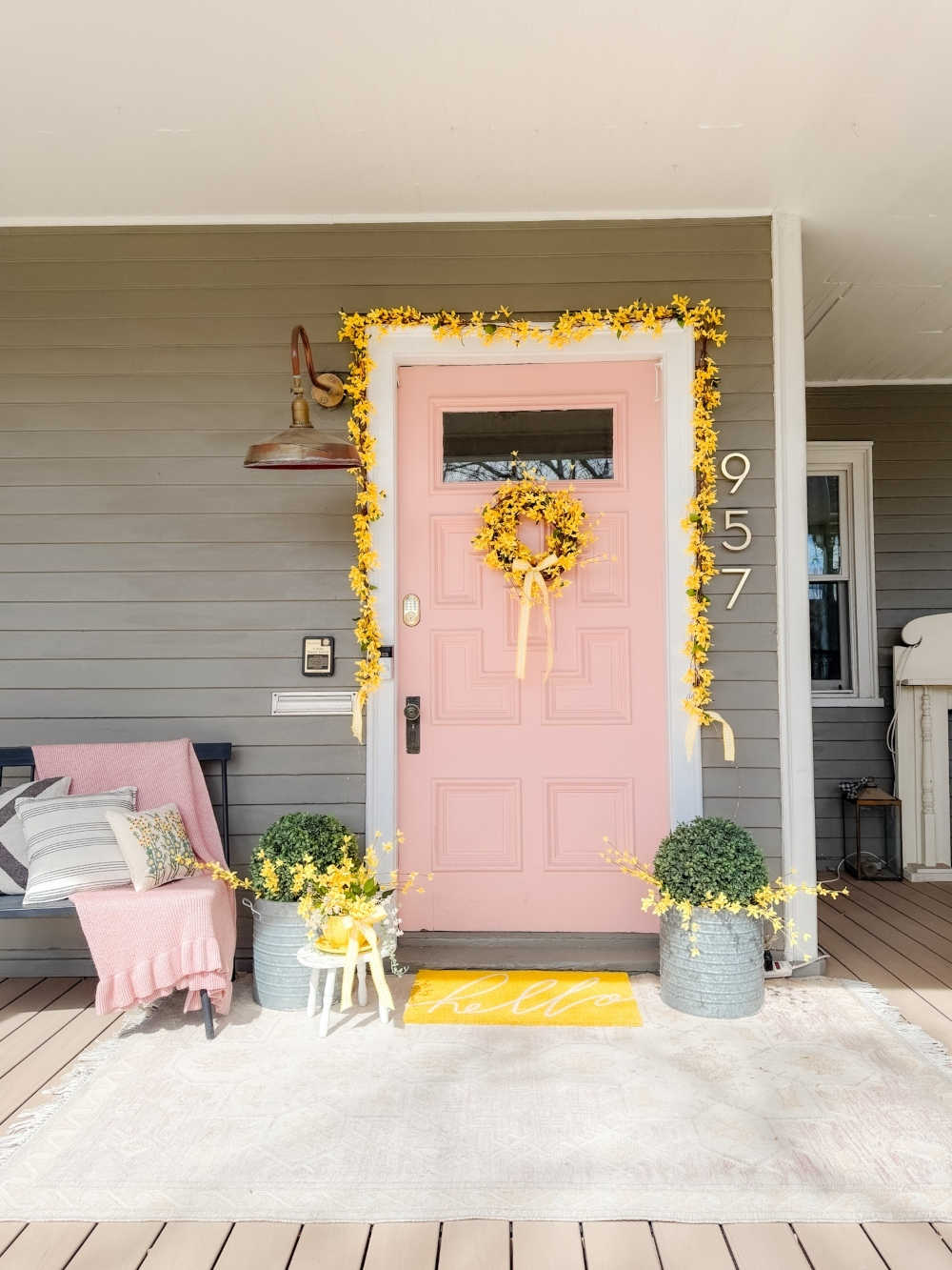 DIY Forsythia Spring Porch! Create a fresh and welcoming spring porch in minutes with vibrant forsythia faux florals, a DIY wreath, a teapot planter and cheerful accents!