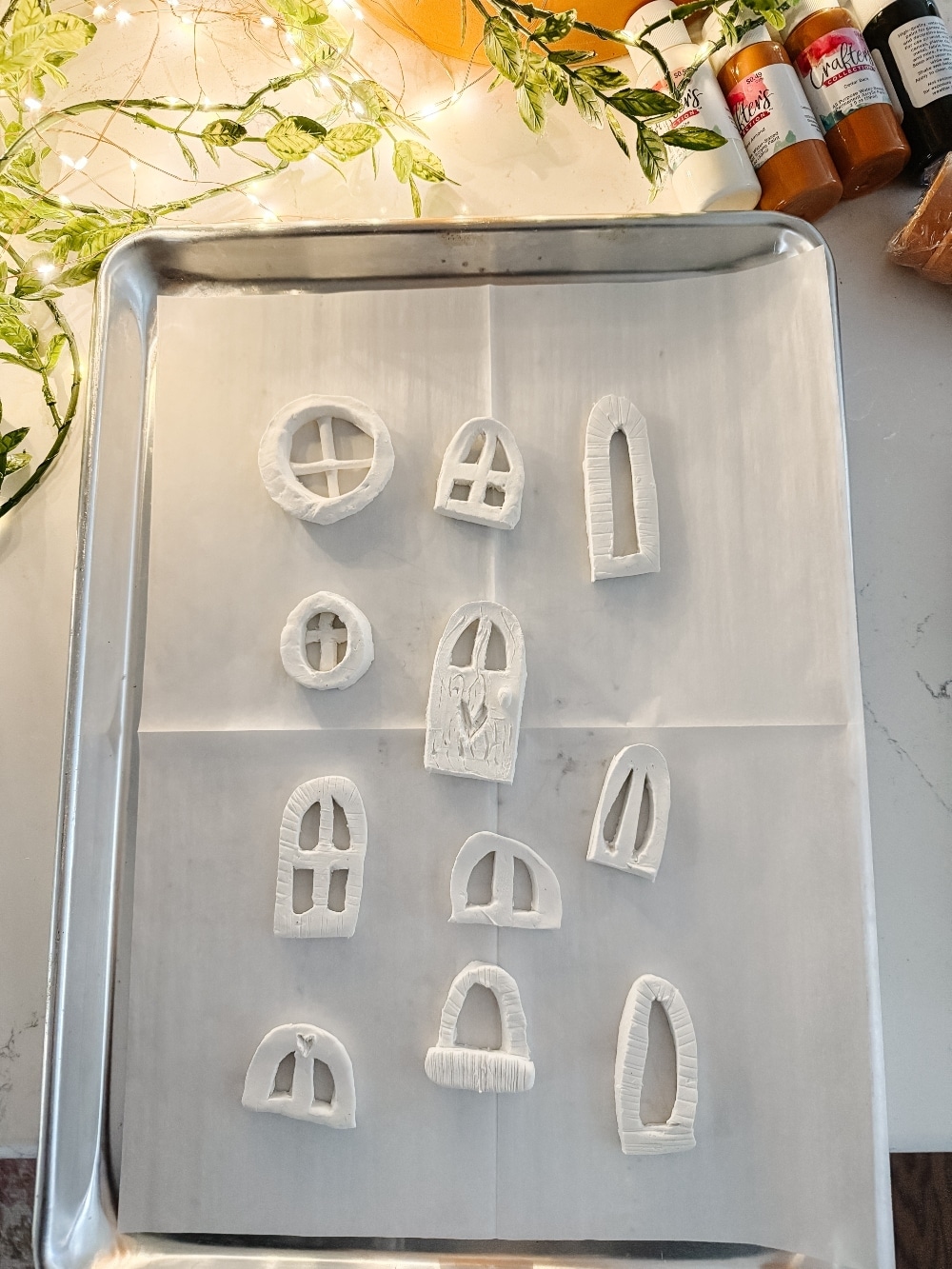 DIY Terra Cotta Pot Fairy Garden – A Magical Spring Craft. Create a whimsical stacked terra cotta fairy garden with clay doors, moss, and magical miniatures to add charm to your spring porch!