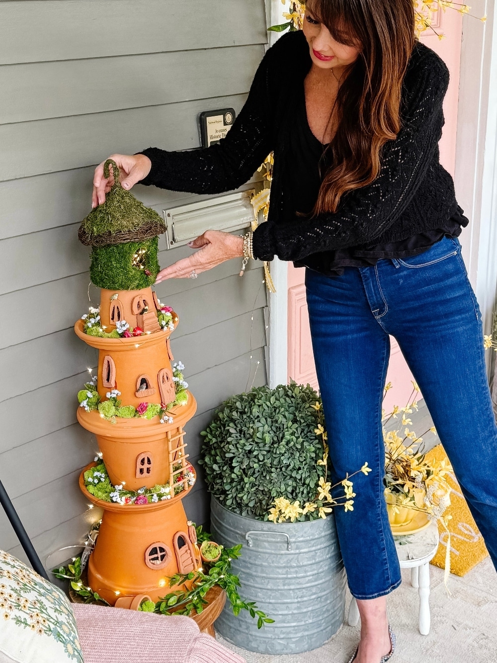 DIY Terra Cotta Pot Fairy Garden – A Magical Spring Craft. Create a whimsical stacked terra cotta fairy garden with clay doors, moss, and magical miniatures to add charm to your spring porch!
