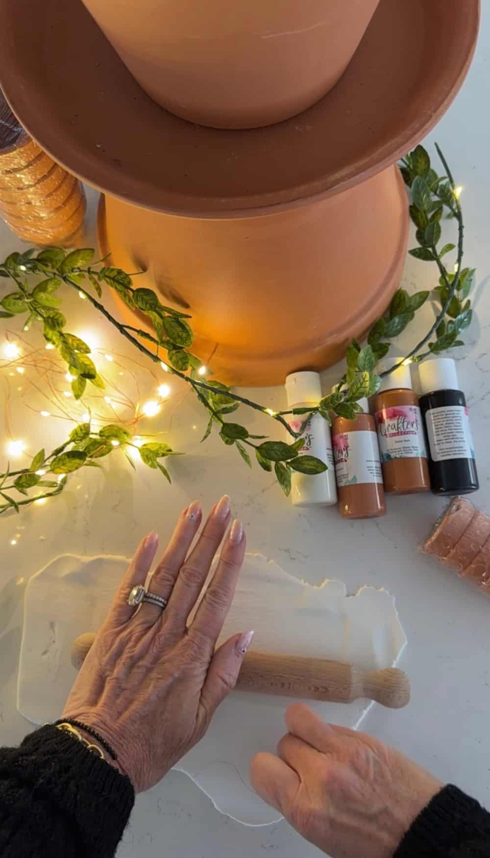 DIY Terra Cotta Pot Fairy Garden – A Magical Spring Craft. Create a whimsical stacked terra cotta fairy garden with clay doors, moss, and magical miniatures to add charm to your spring porch!