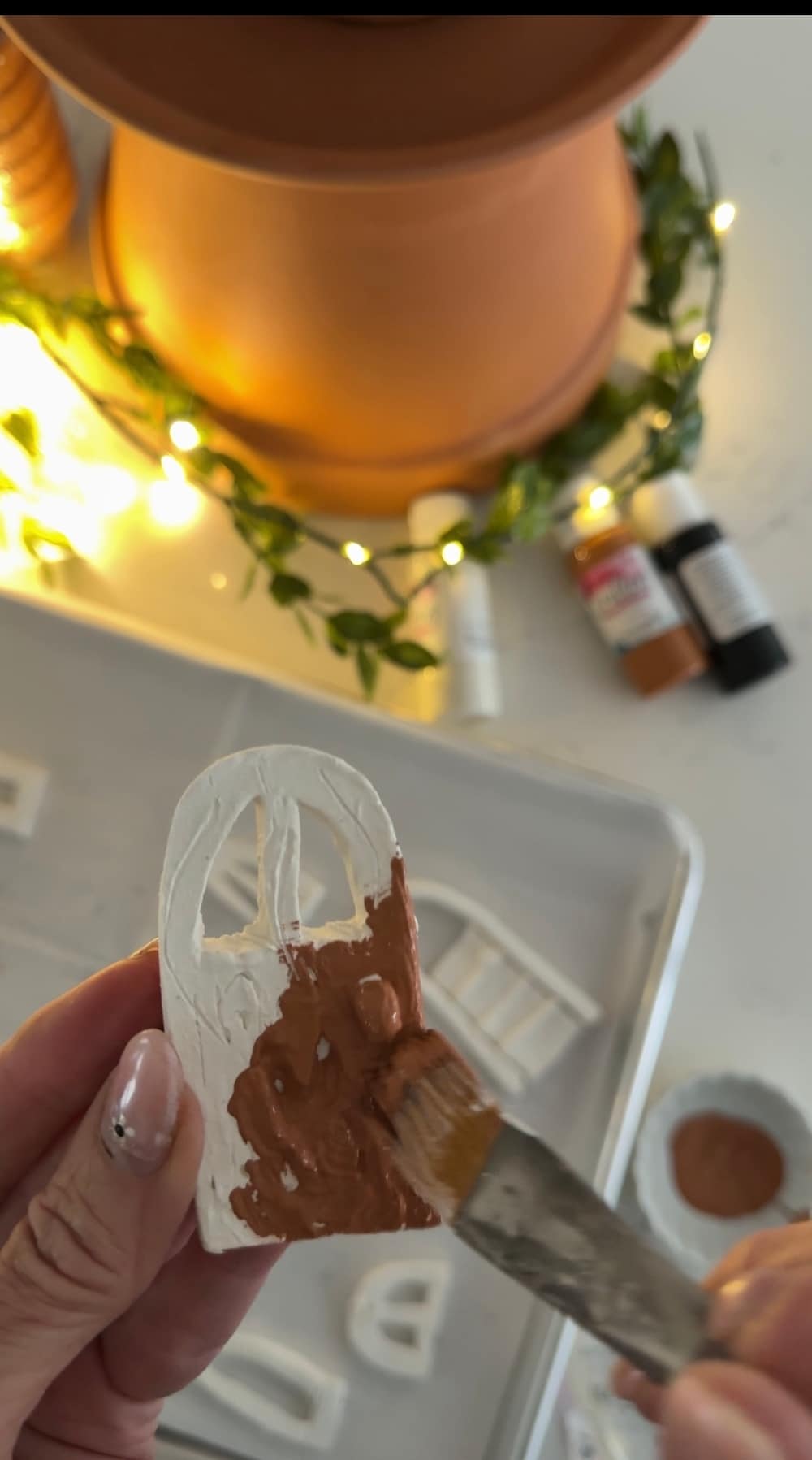 DIY Terra Cotta Pot Fairy Garden – A Magical Spring Craft. Create a whimsical stacked terra cotta fairy garden with clay doors, moss, and magical miniatures to add charm to your spring porch!