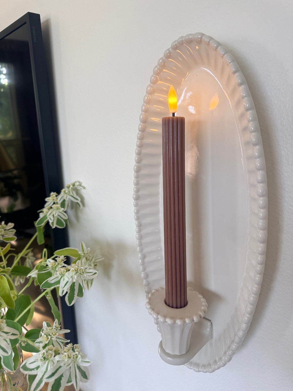 $30 Ceramic Candle Wall Sconces That Look Like Designer Lighting. Create the cozy glow of designer lighting with affordable ceramic candle wall sconces and realistic flameless taper candles.