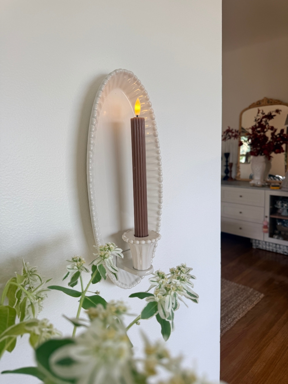 $30 Ceramic Candle Wall Sconces That Look Like Designer Lighting. Create the cozy glow of designer lighting with affordable ceramic candle wall sconces and realistic flameless taper candles.