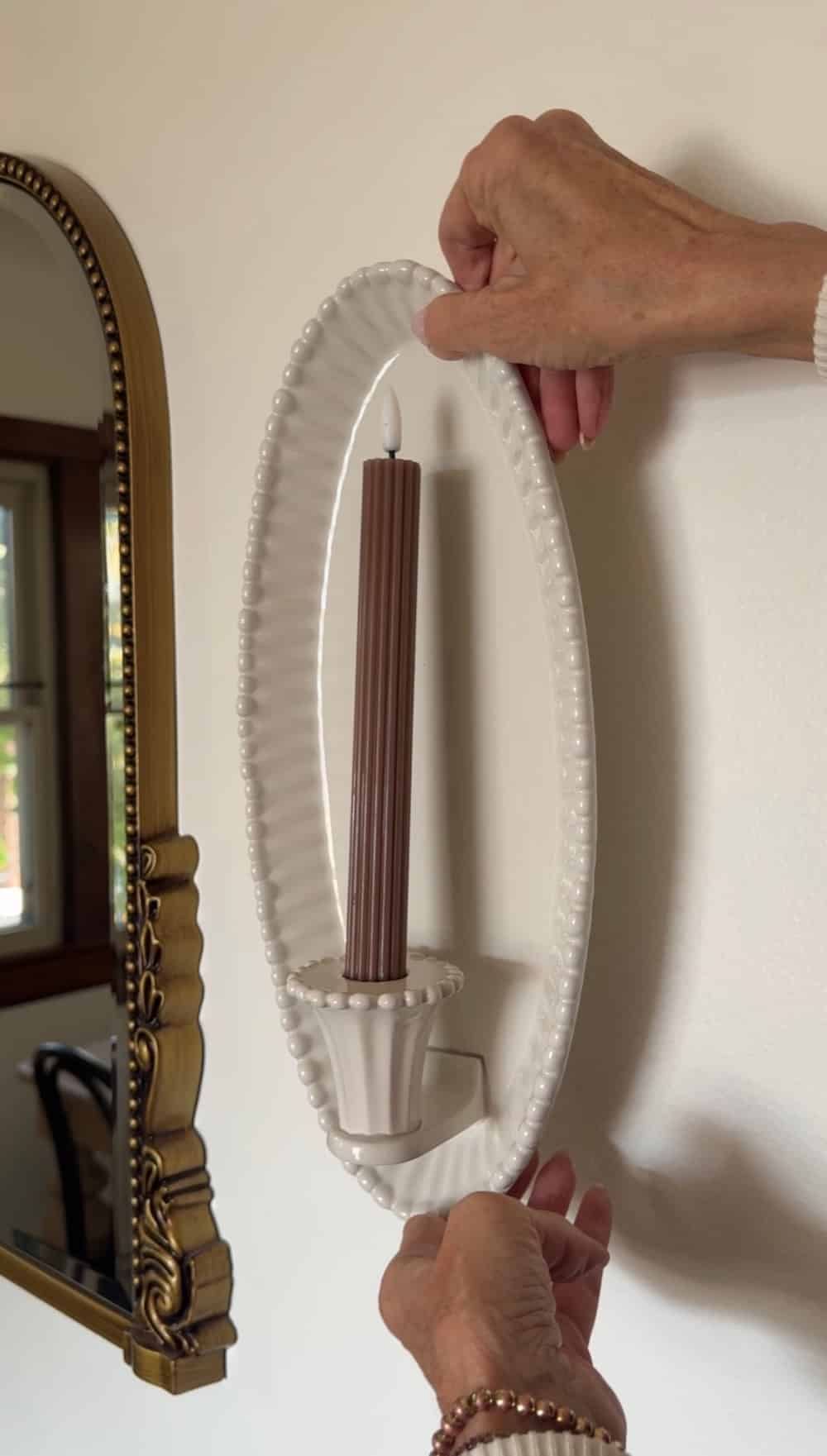 $30 Ceramic Candle Wall Sconces That Look Like Designer Lighting. Create the cozy glow of designer lighting with affordable ceramic candle wall sconces and realistic flameless taper candles.