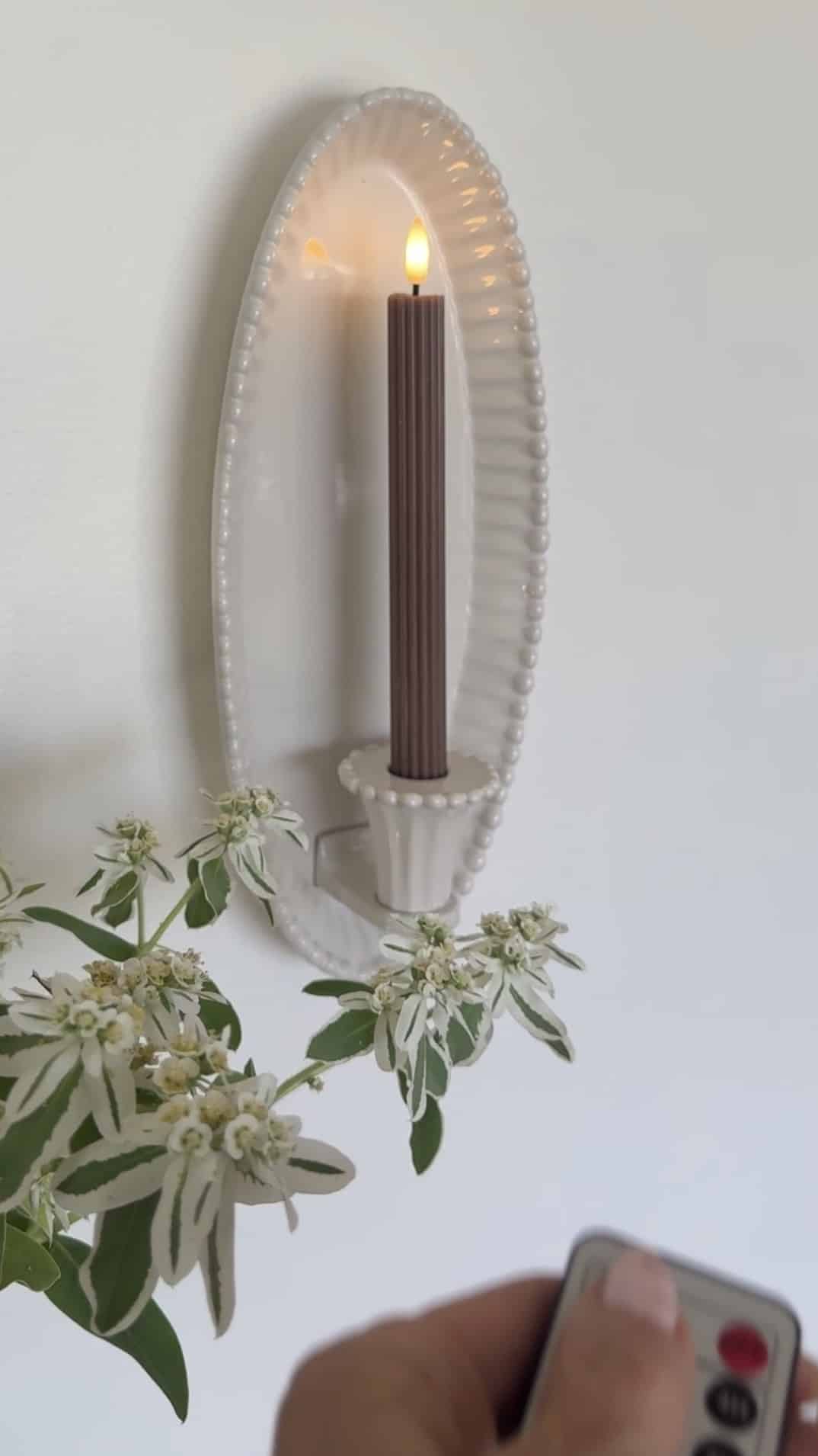 $30 Ceramic Candle Wall Sconces That Look Like Designer Lighting. Create the cozy glow of designer lighting with affordable ceramic candle wall sconces and realistic flameless taper candles.