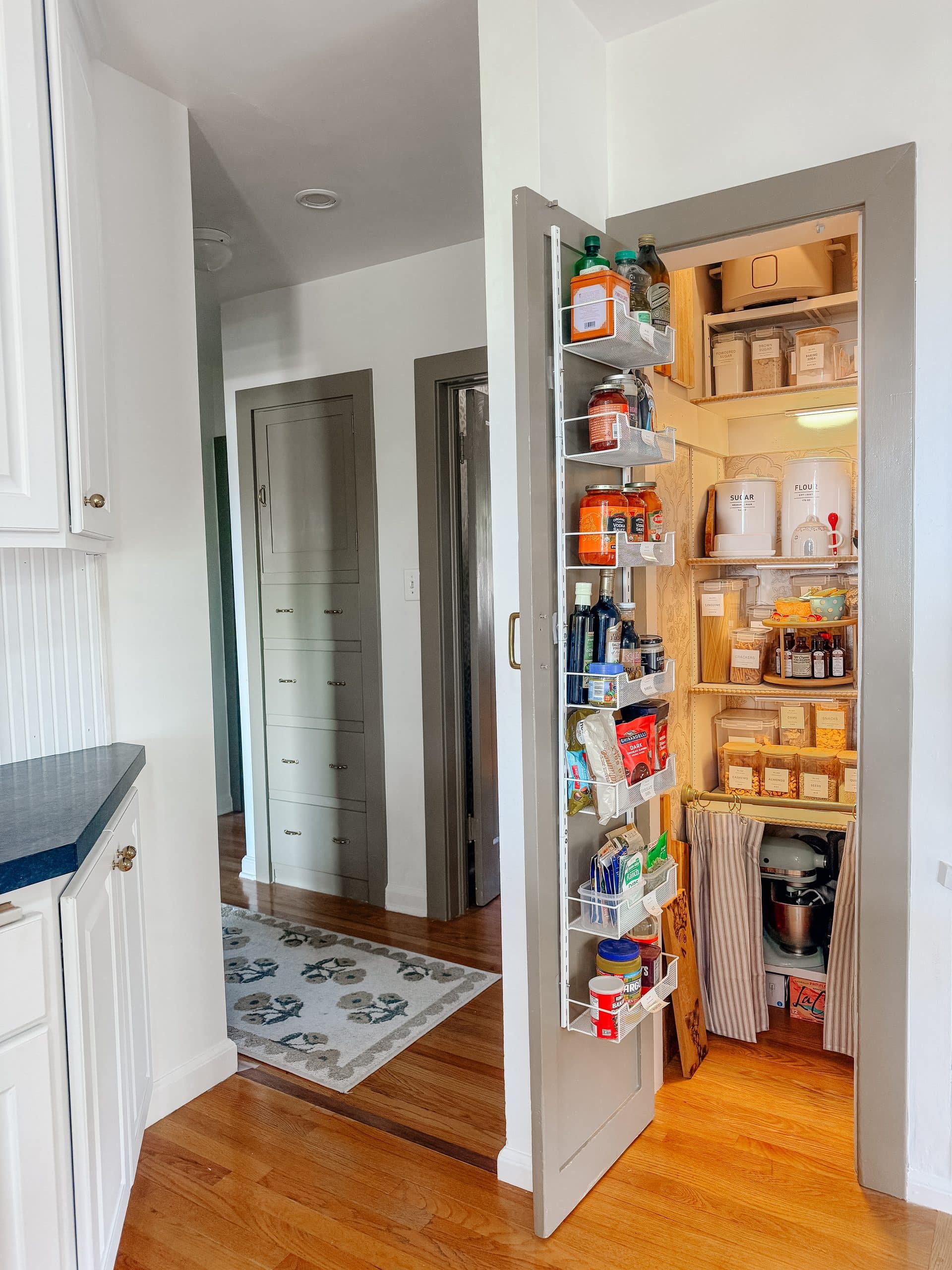 This tiny pantry makeover proves that you don’t need a huge space to create beautiful, functional storage. I transformed the original pantry in my 1932 Tudor with smart storage solutions, wallpaper, pretty containers, a baking station, appliance storage, and vintage-inspired details that make every inch work harder.