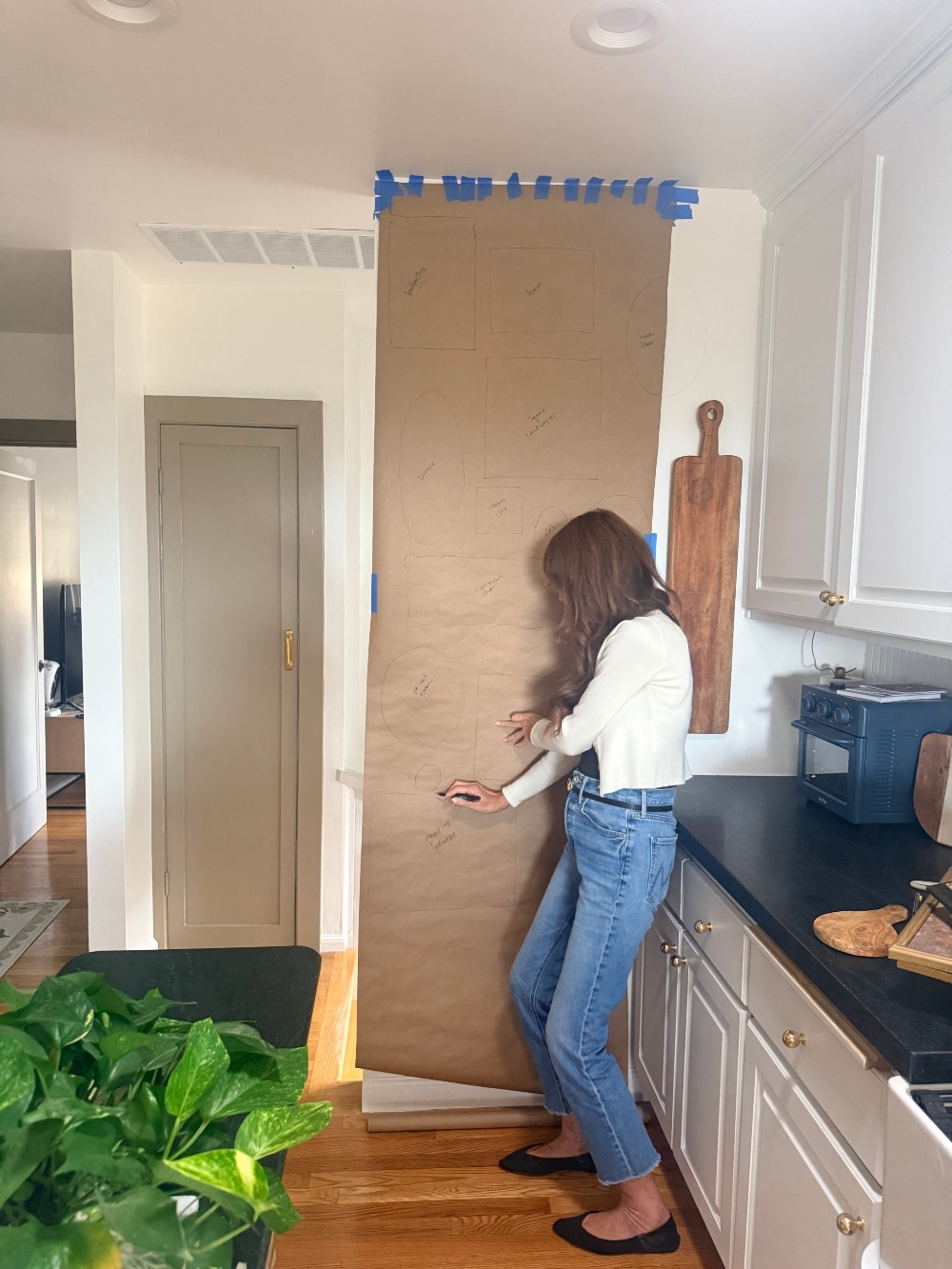How to Create a Beautiful Gallery Wall Using a Butcher Paper Template. Create a beautifully collected gallery wall with perfect spacing using this easy butcher paper template method, plus a clever way to disguise an awkward light switch.