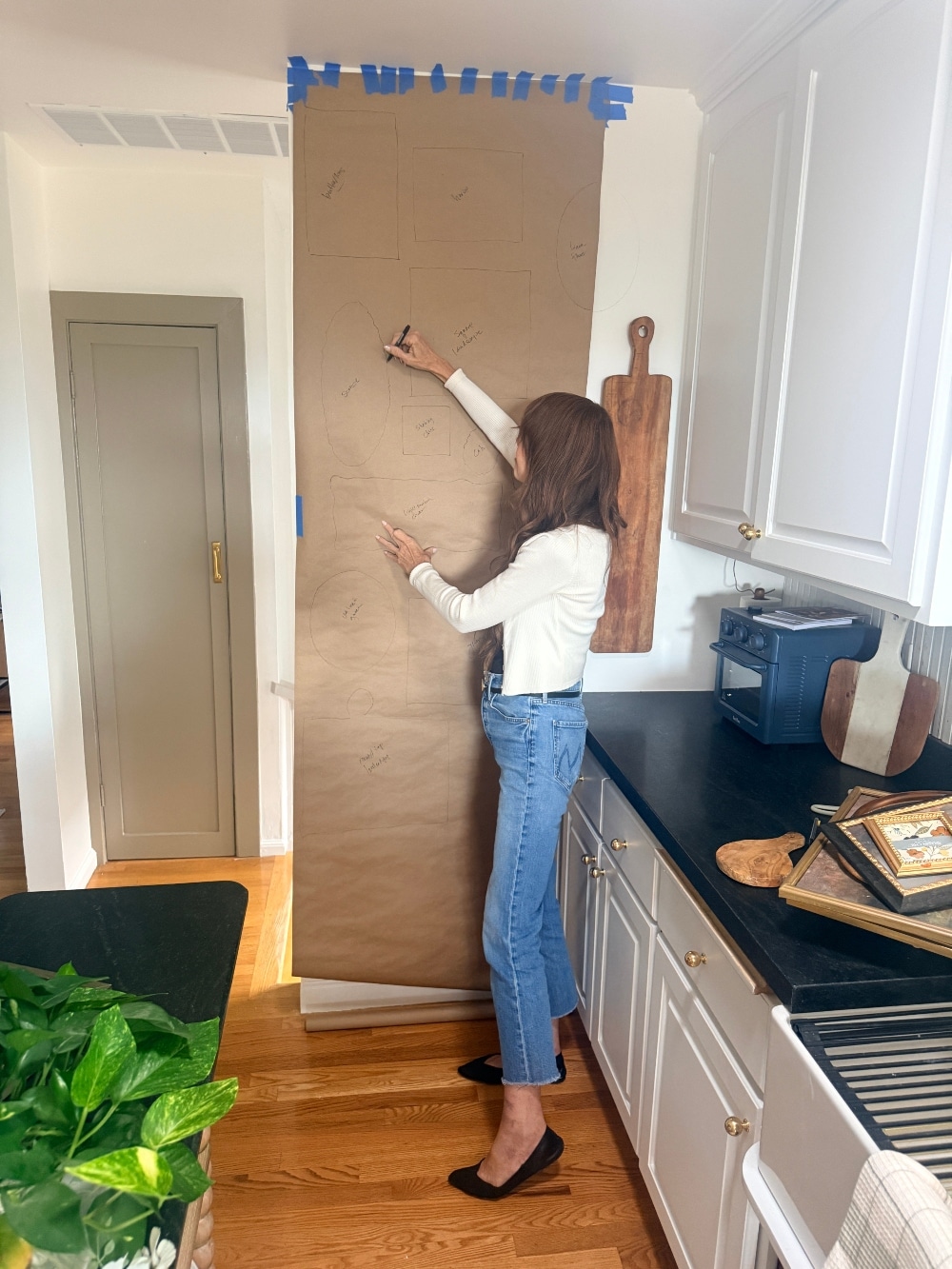 How to Create a Beautiful Gallery Wall Using a Butcher Paper Template. Create a beautifully collected gallery wall with perfect spacing using this easy butcher paper template method, plus a clever way to disguise an awkward light switch.