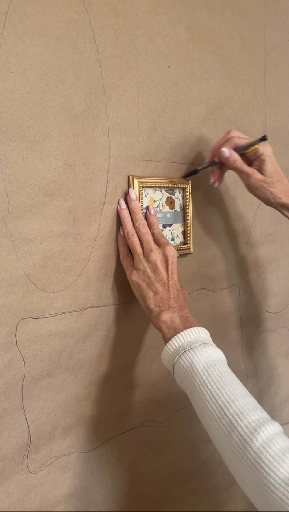 How to Create a Beautiful Gallery Wall Using a Butcher Paper Template. Create a beautifully collected gallery wall with perfect spacing using this easy butcher paper template method, plus a clever way to disguise an awkward light switch.
